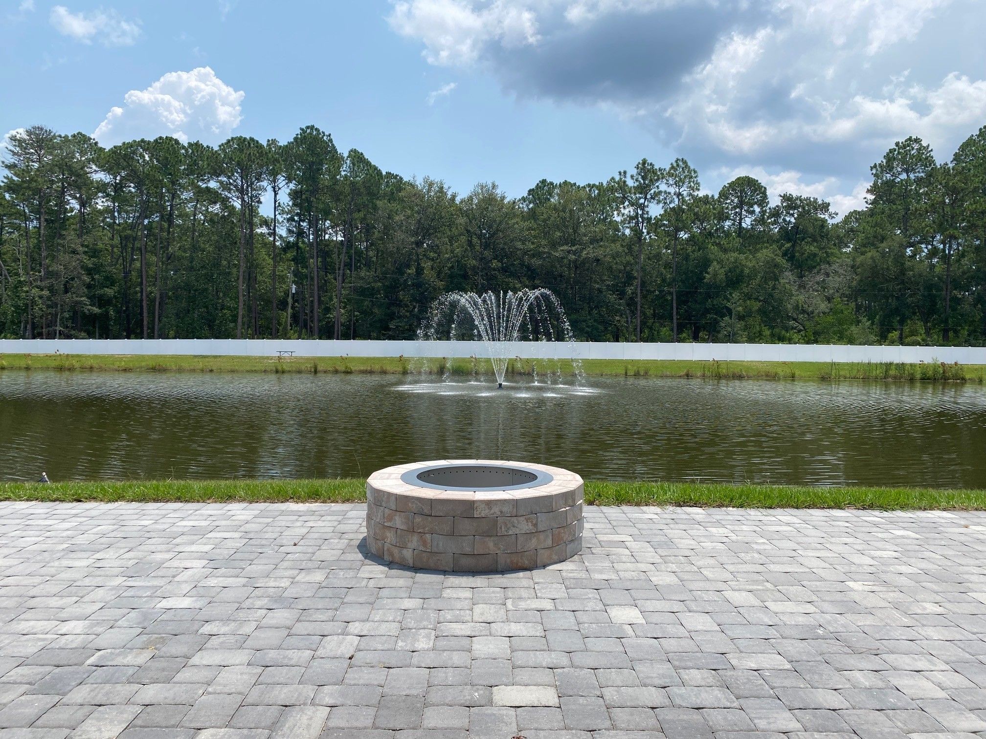 Gather around the community fire pit by the lake and pavilion
