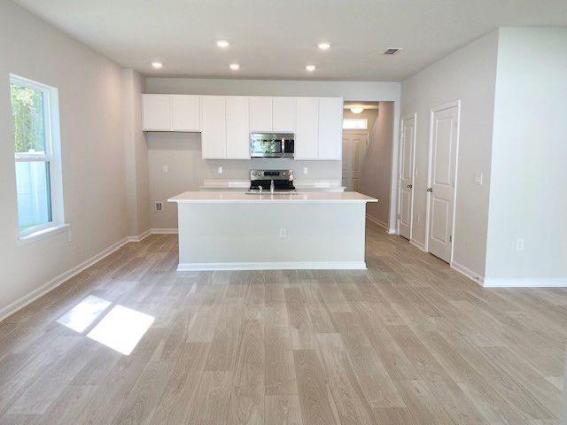 Ashley Laurel Oaks features white cabinets and quartz countertops