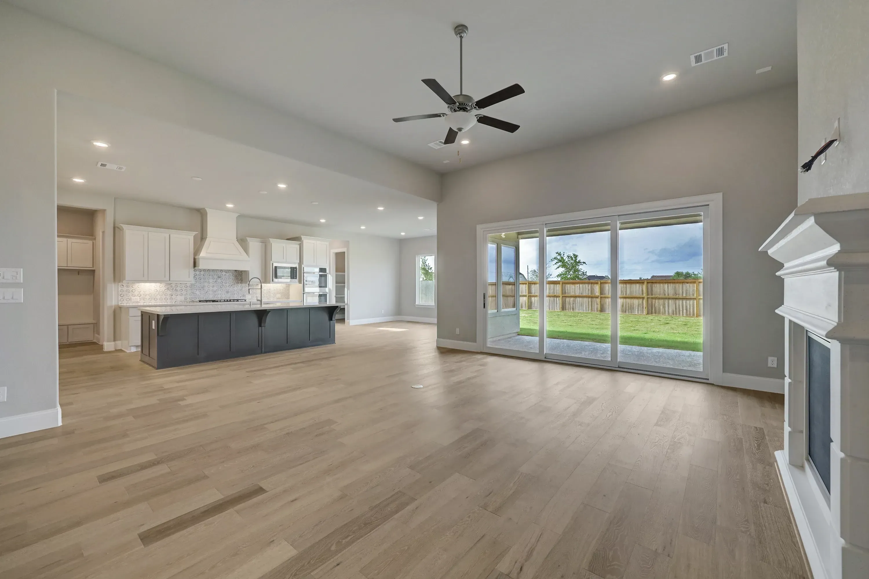 Plan 6025 great room w/ fireplace, SS doors, EOL