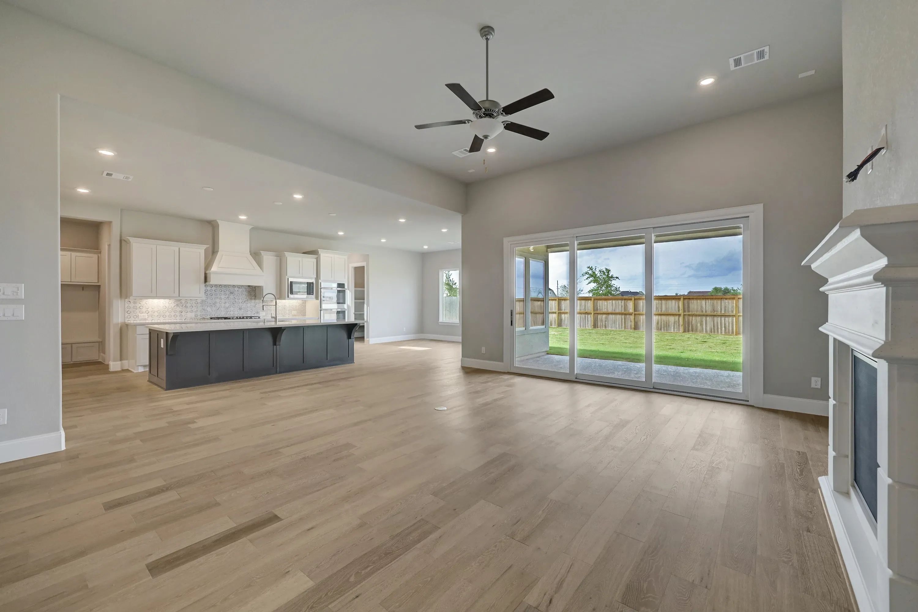 Plan 6025 great room w/ fireplace, SS doors, EOL