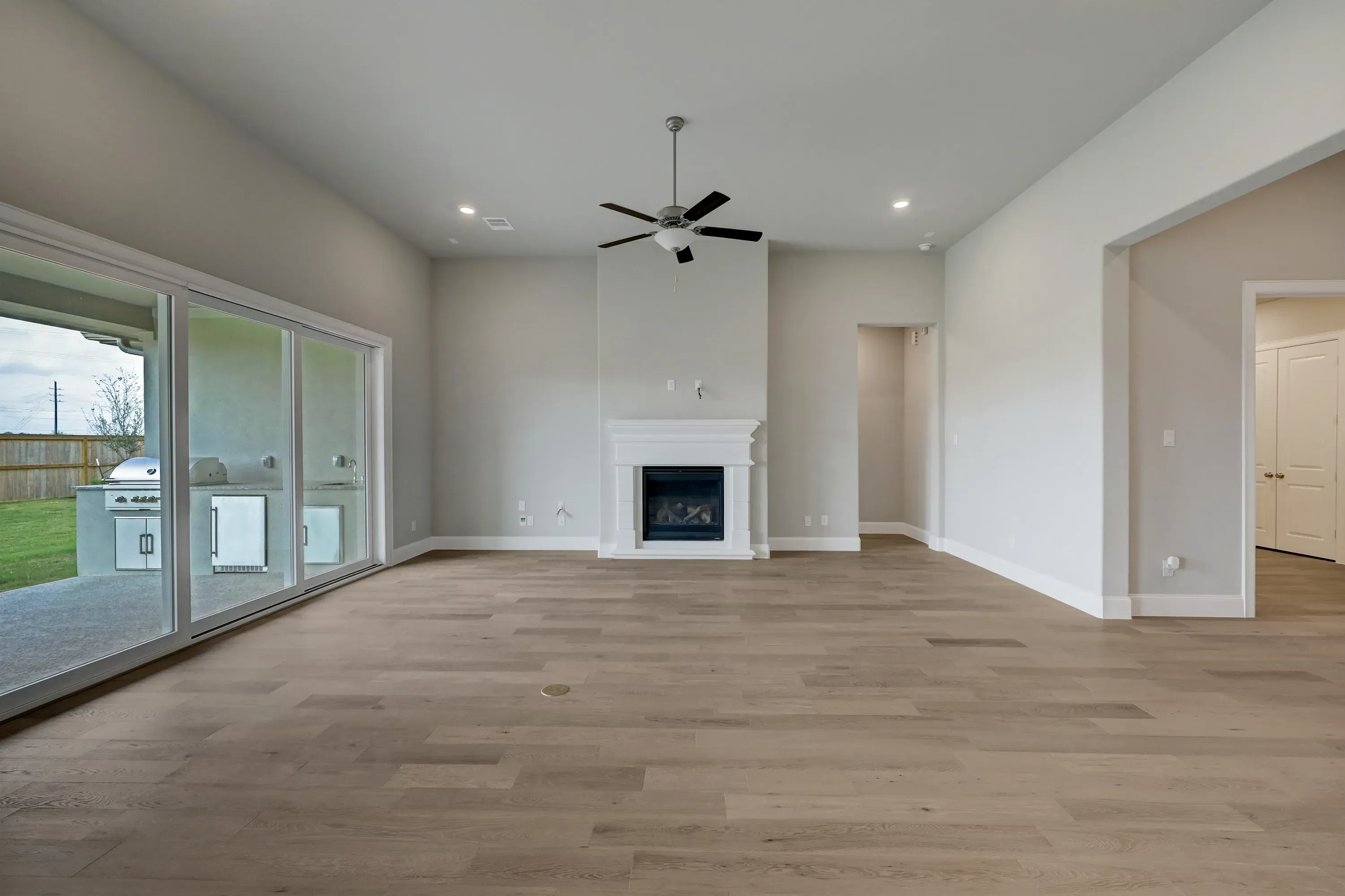 Plan 6025 great room w/ fireplace, SS doors, EOL