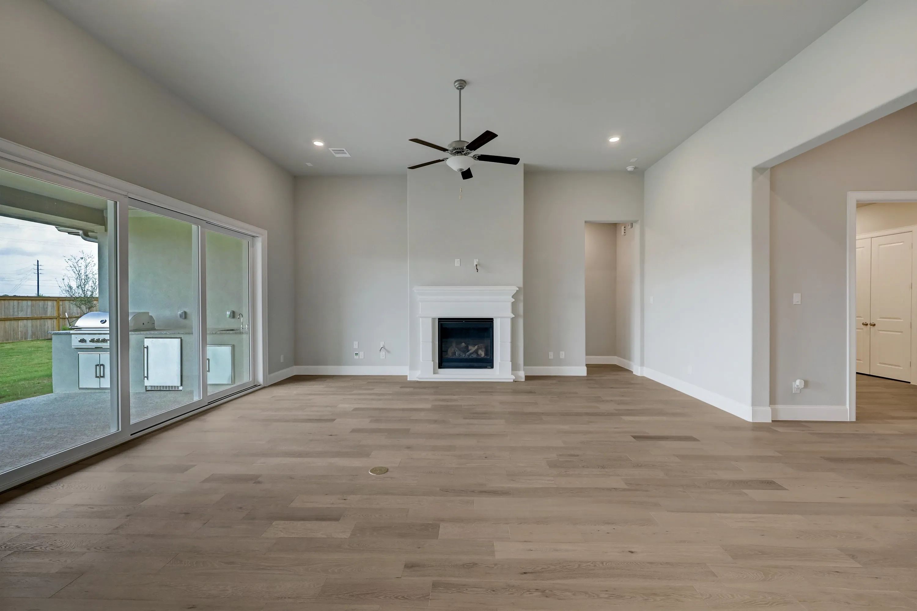 Plan 6025 great room w/ fireplace, SS doors, EOL