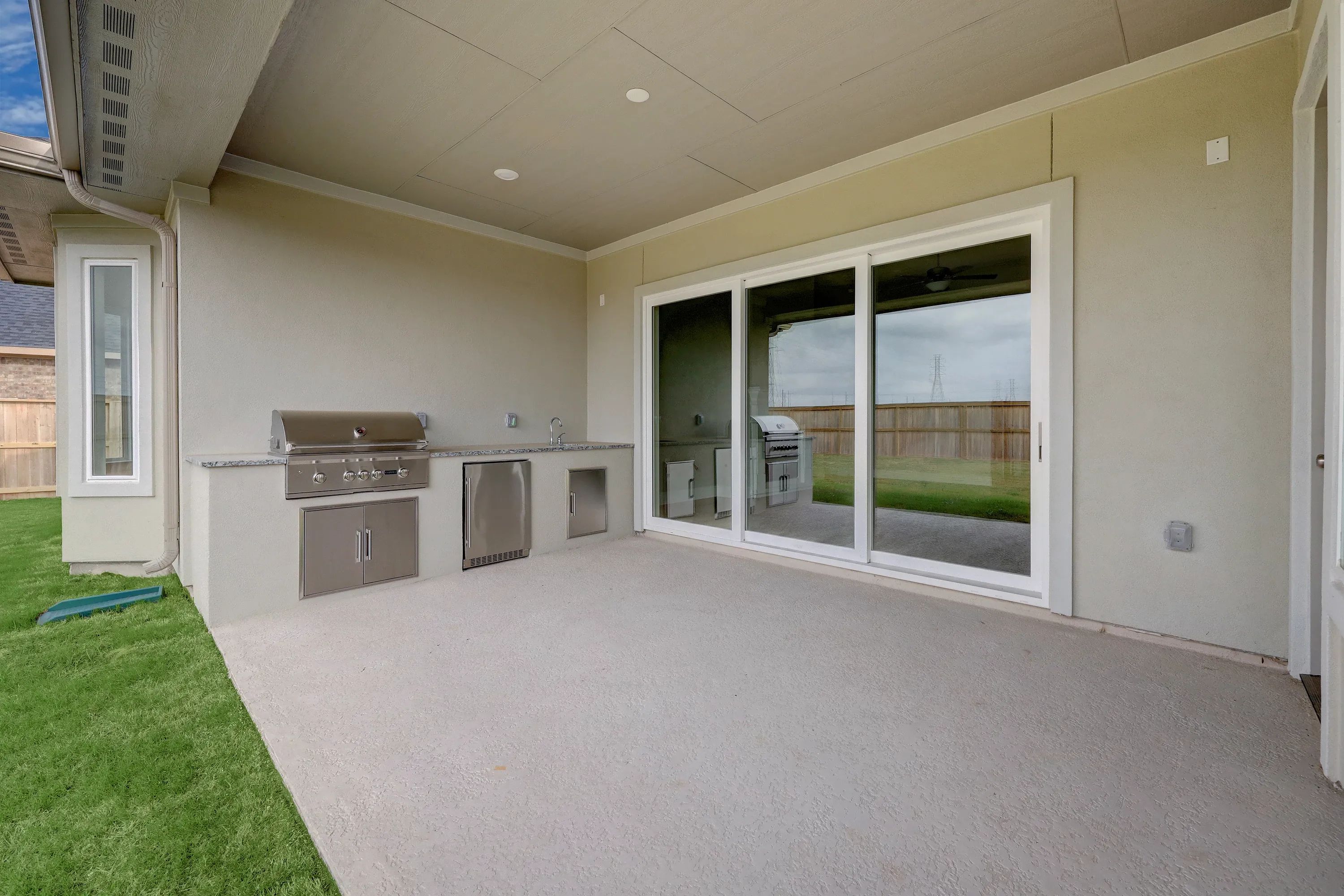 Plan 6025 patio w/ SS doors, outdoor kitchen