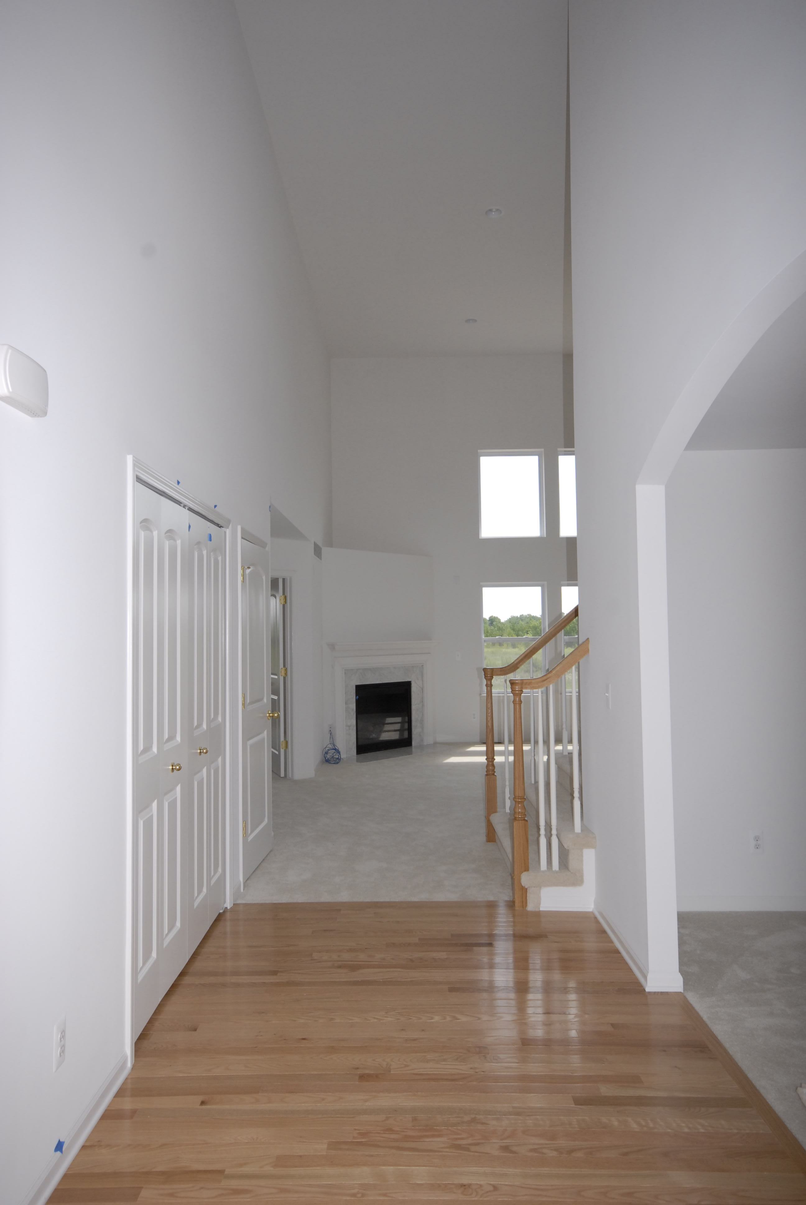 View from entry through the open design plan to the great room with expansive windows and vaulted ce