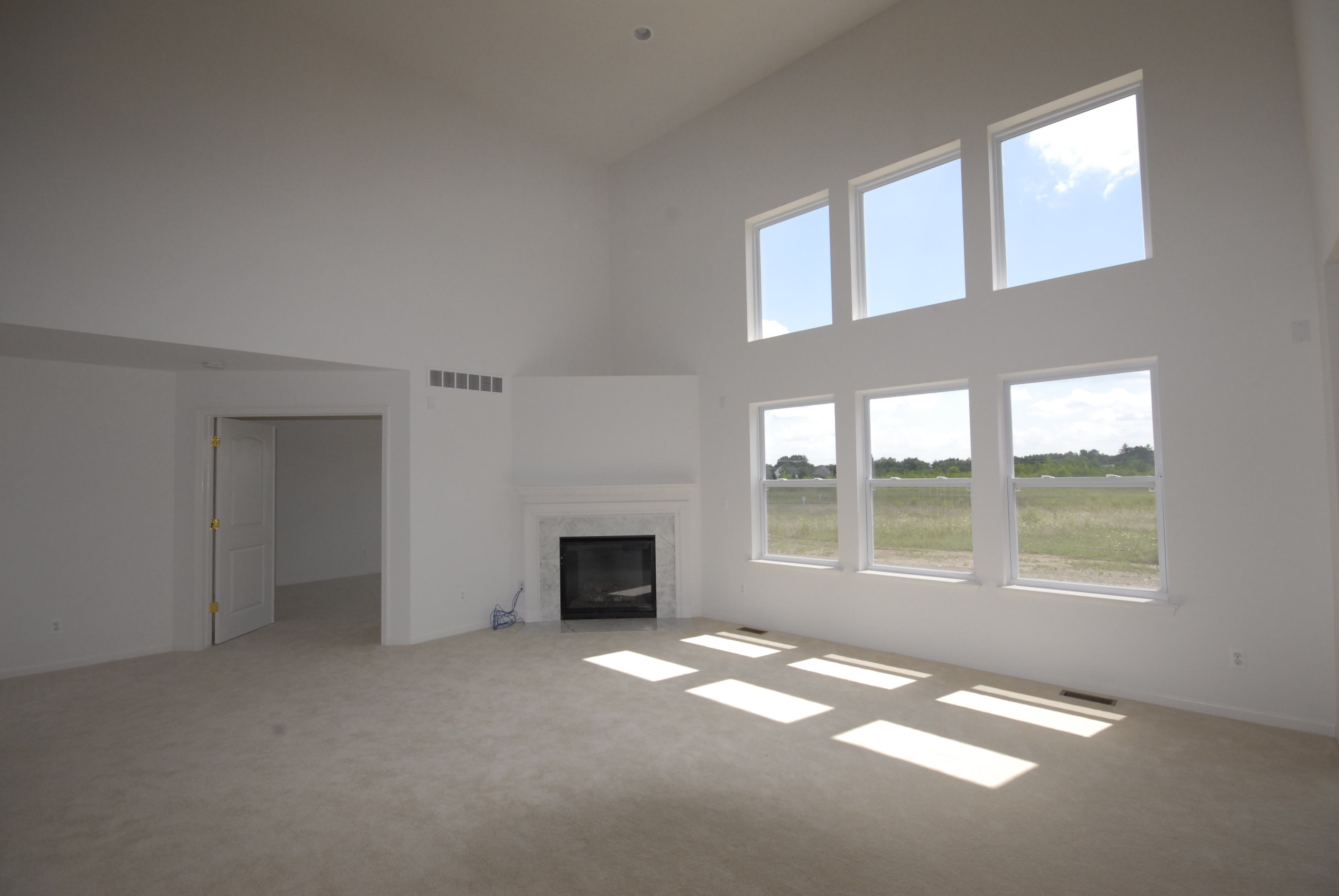 Expansive windows and vaulted ceiling offer open elegance to the spacious great room.