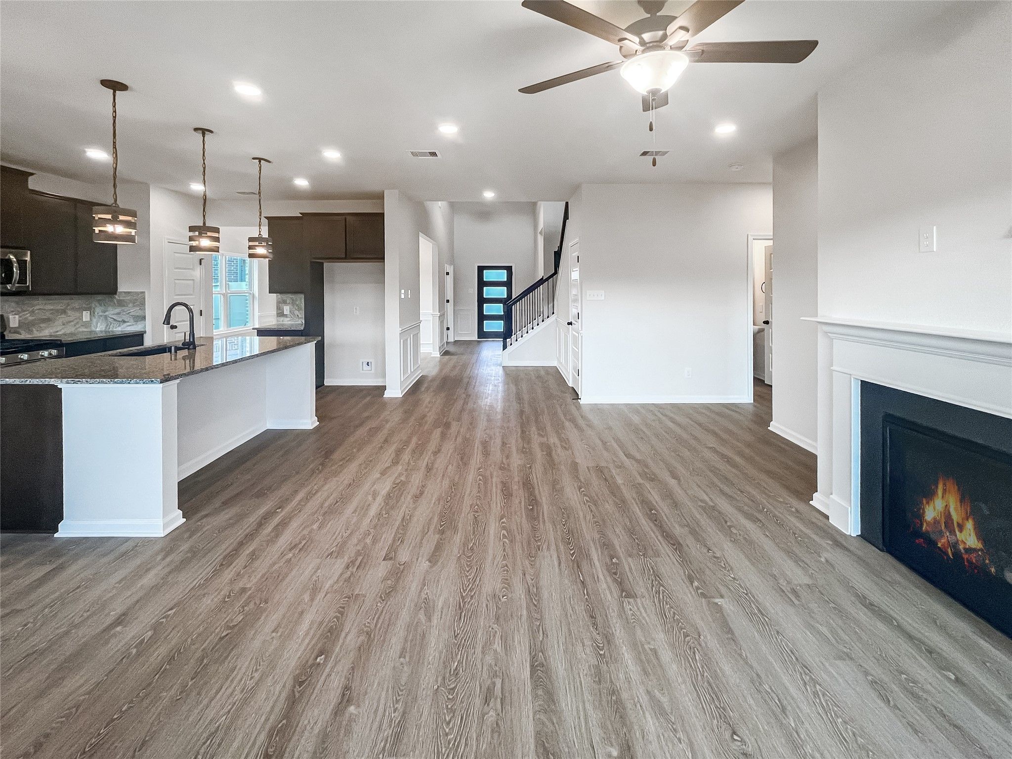 The Princeton II- Family Room with Fireplace into Kitchen.
