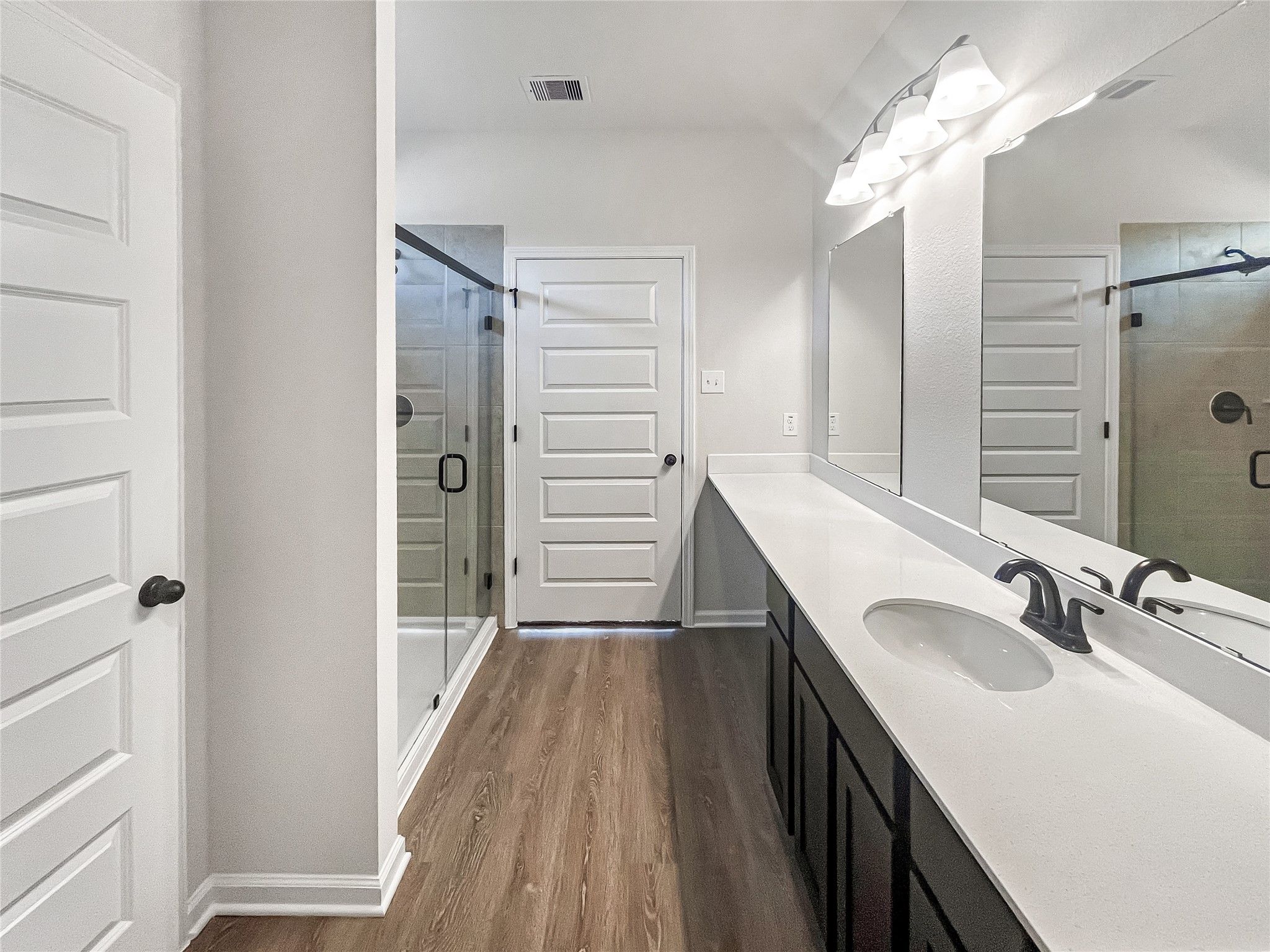 The Princeton II- Primary Bathroom with Dual Vanities and large Walk-in Shower.