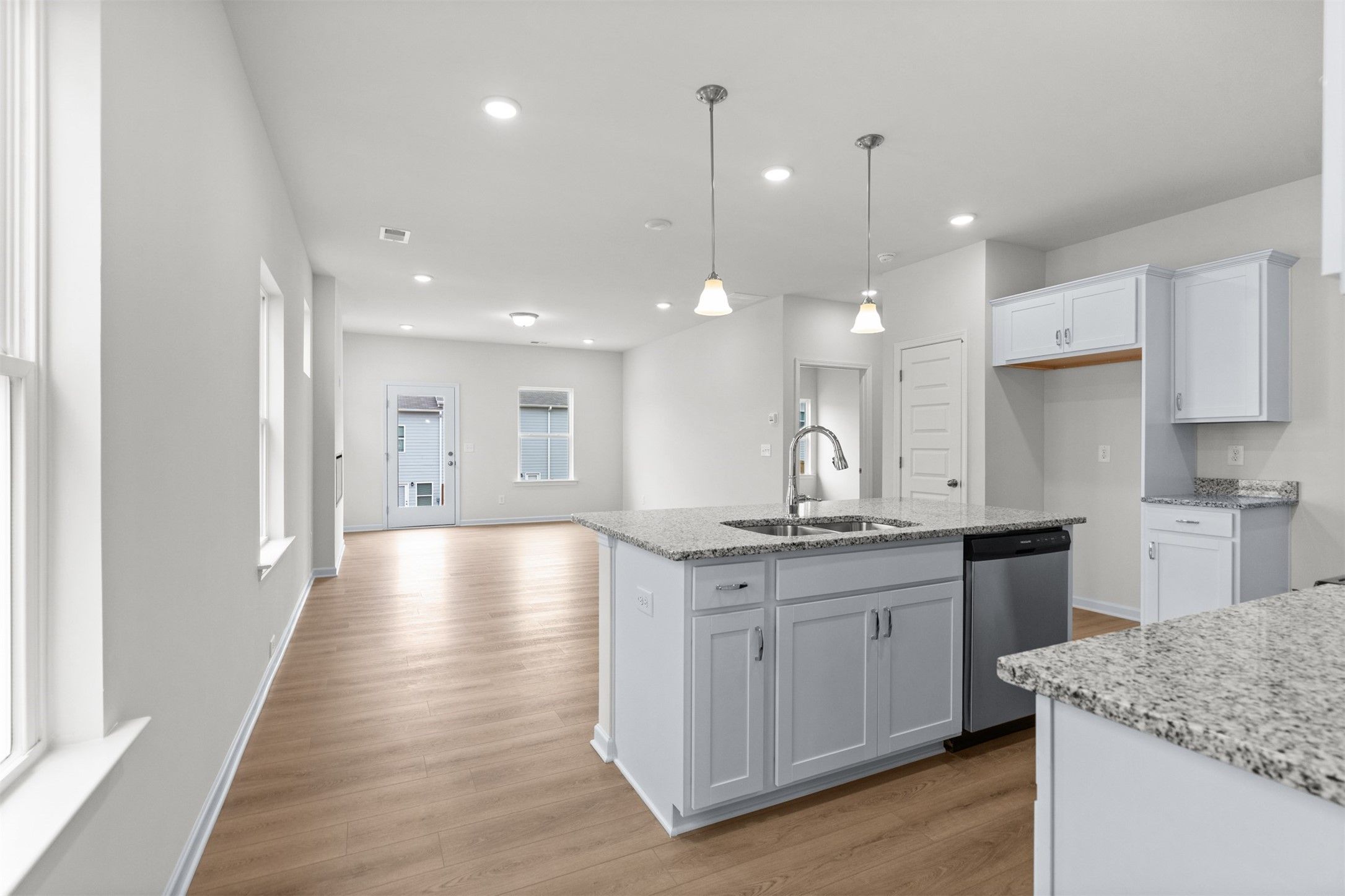 The Dove- Kitchen into Family Room. Home under construction, photo used for illustrative purposes o