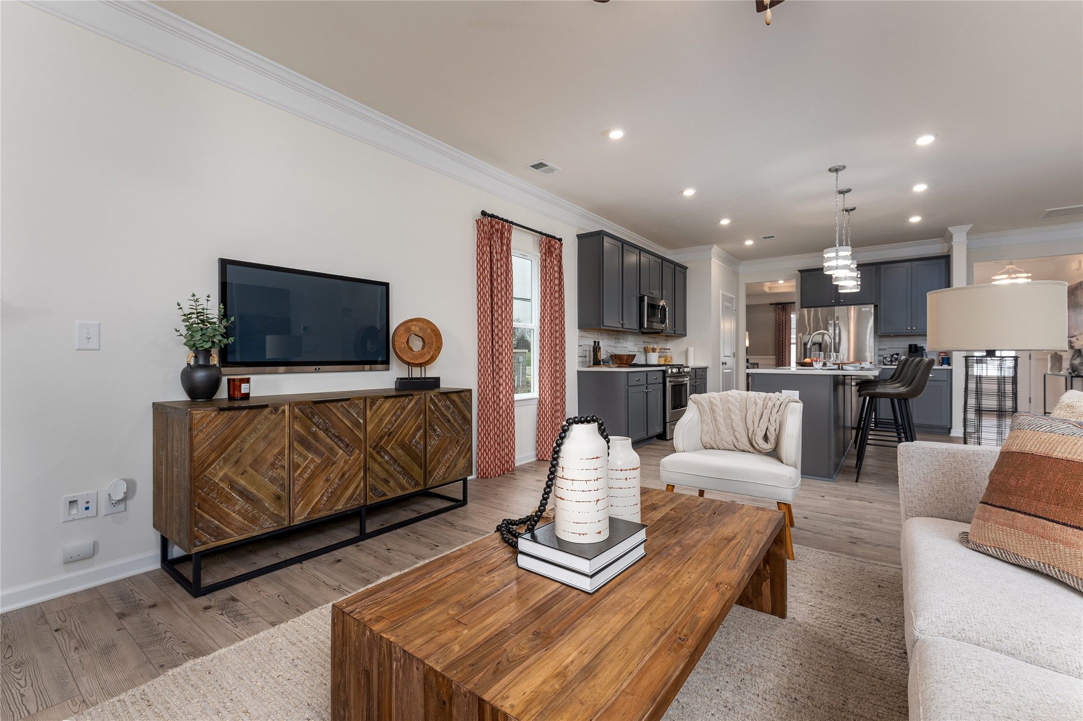 The Palmer- Family Room into the Kitchen. The sample image is a staged model, to be used for illust