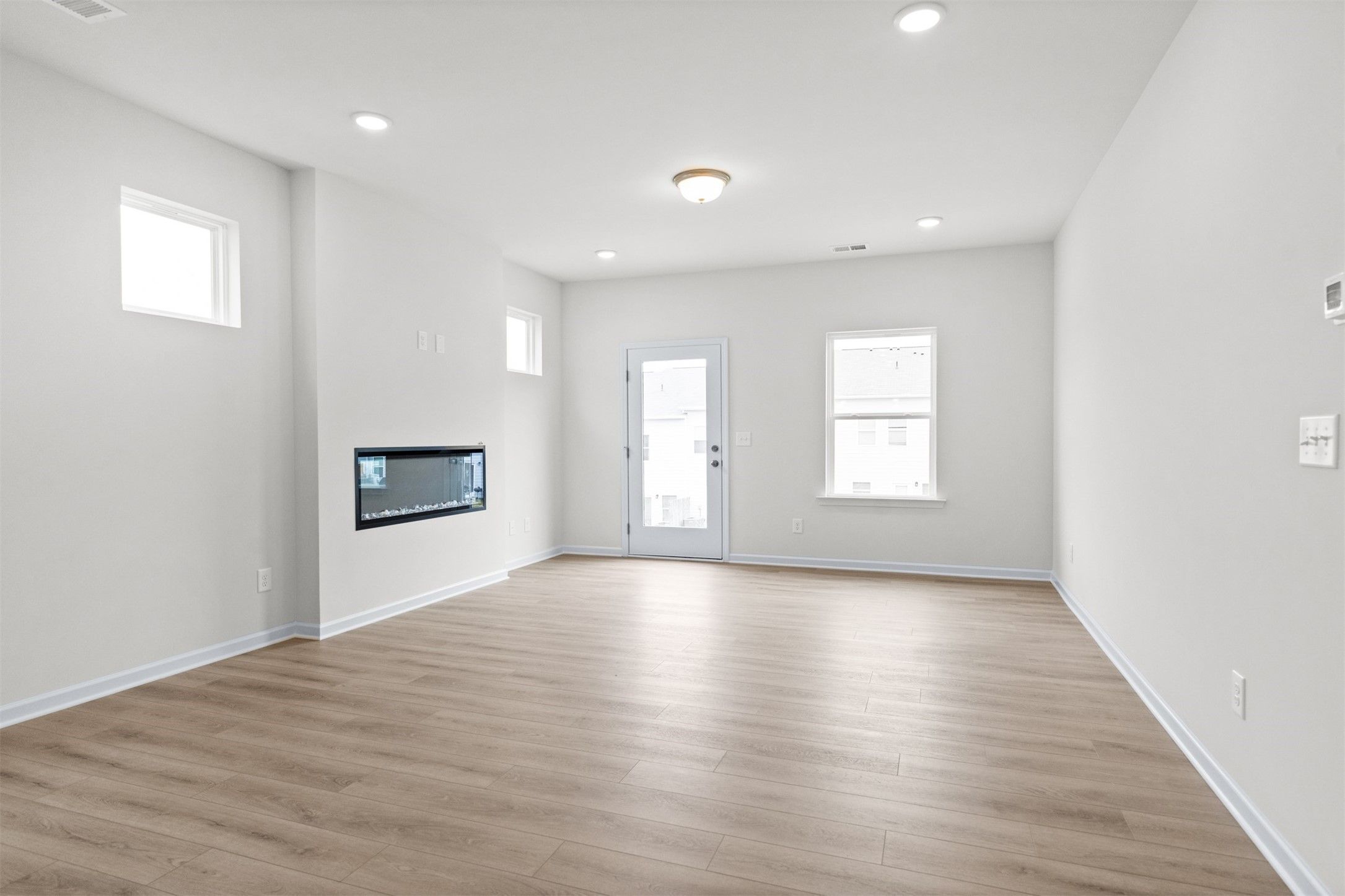 The Dove- Family Room with Linear Electric Fireplace. Home under construction, photo used for illus
