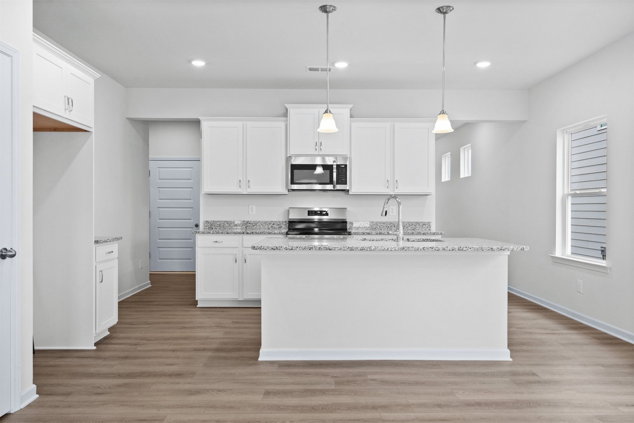 The Dove- Kitchen with Island. Home under construction, photo used for illustrative purposes only,