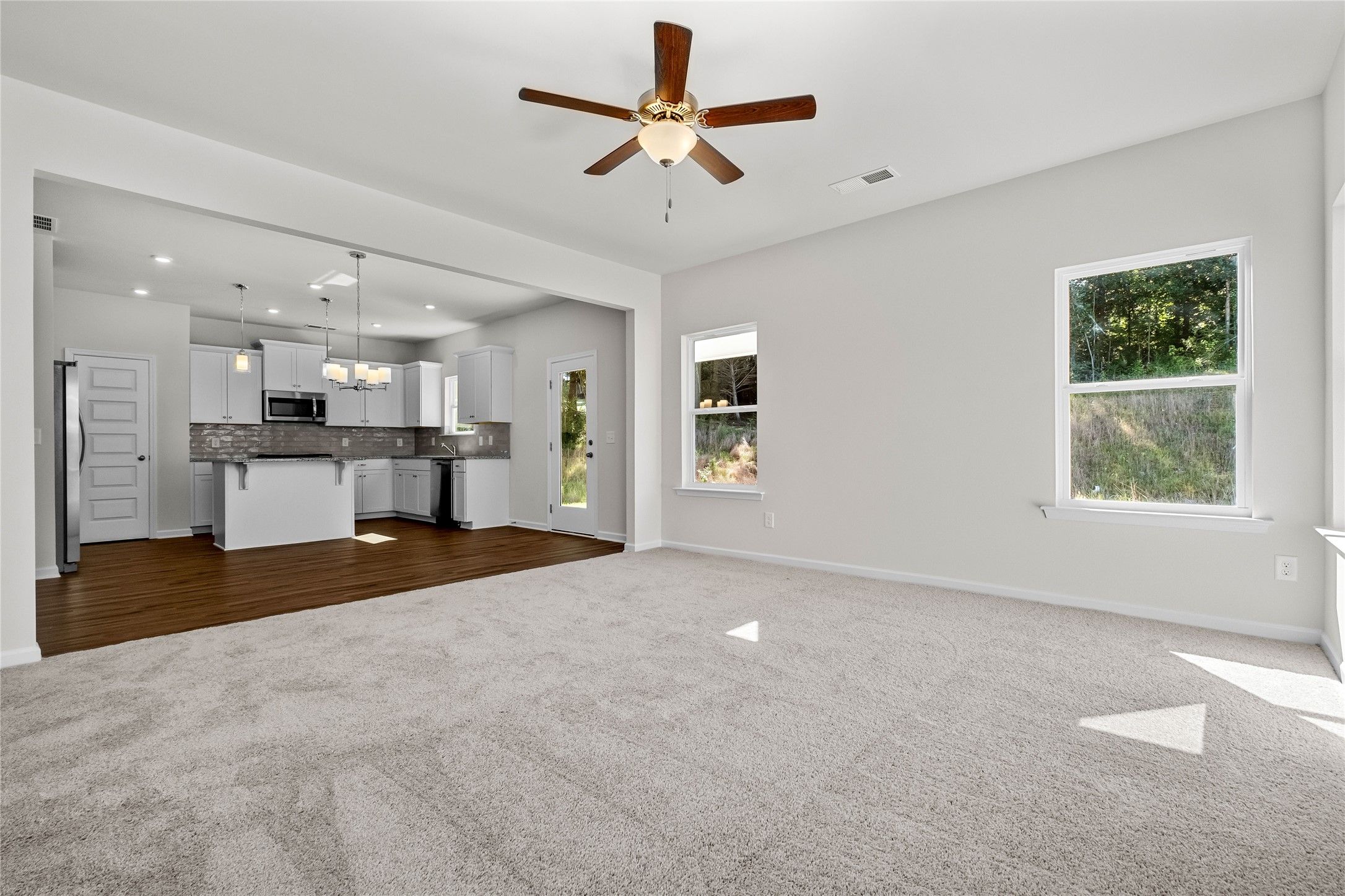 The Coleman- Family Room into kitchen. Home under construction, photo used for illustrative purpose