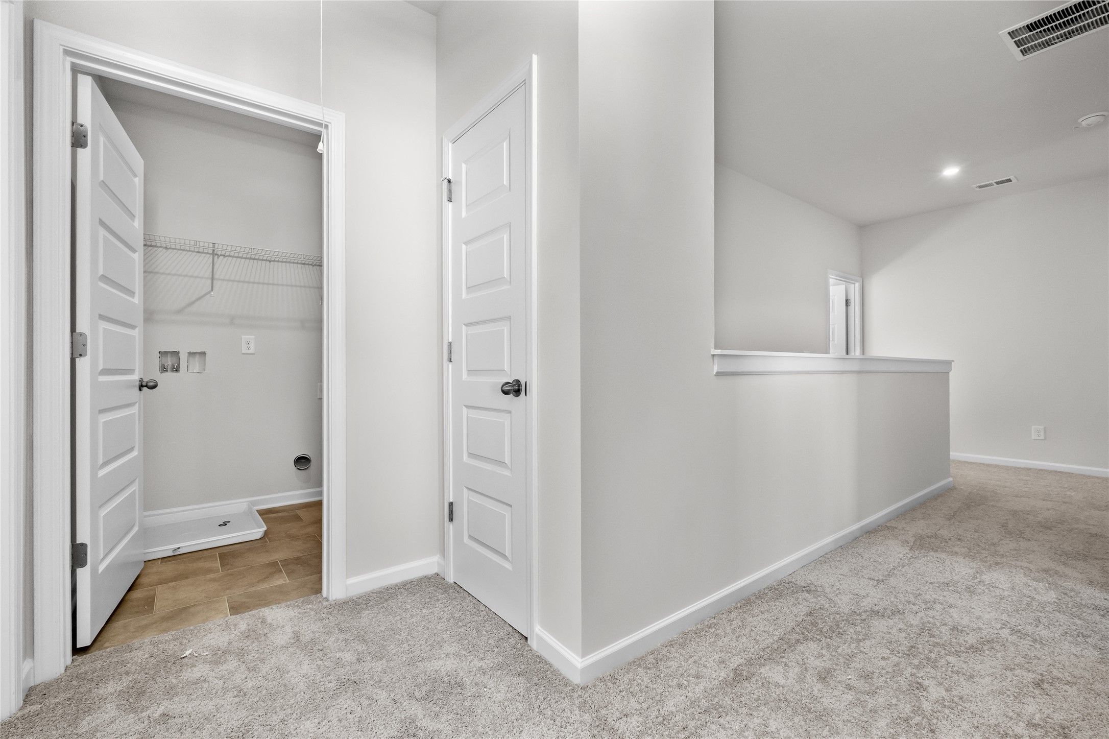 The Coleman- 2nd floor landing into utility room. Home under construction, photo used for illustrat