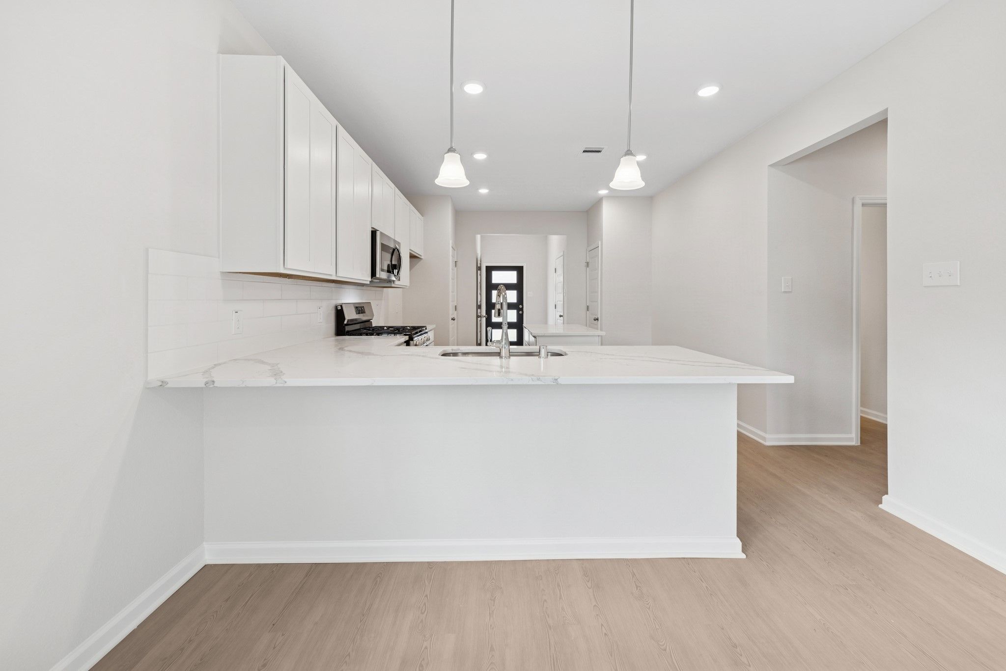 The Cardinal II- Dining Area into Kitchen. Photos of home shown are for illustration only; actual f