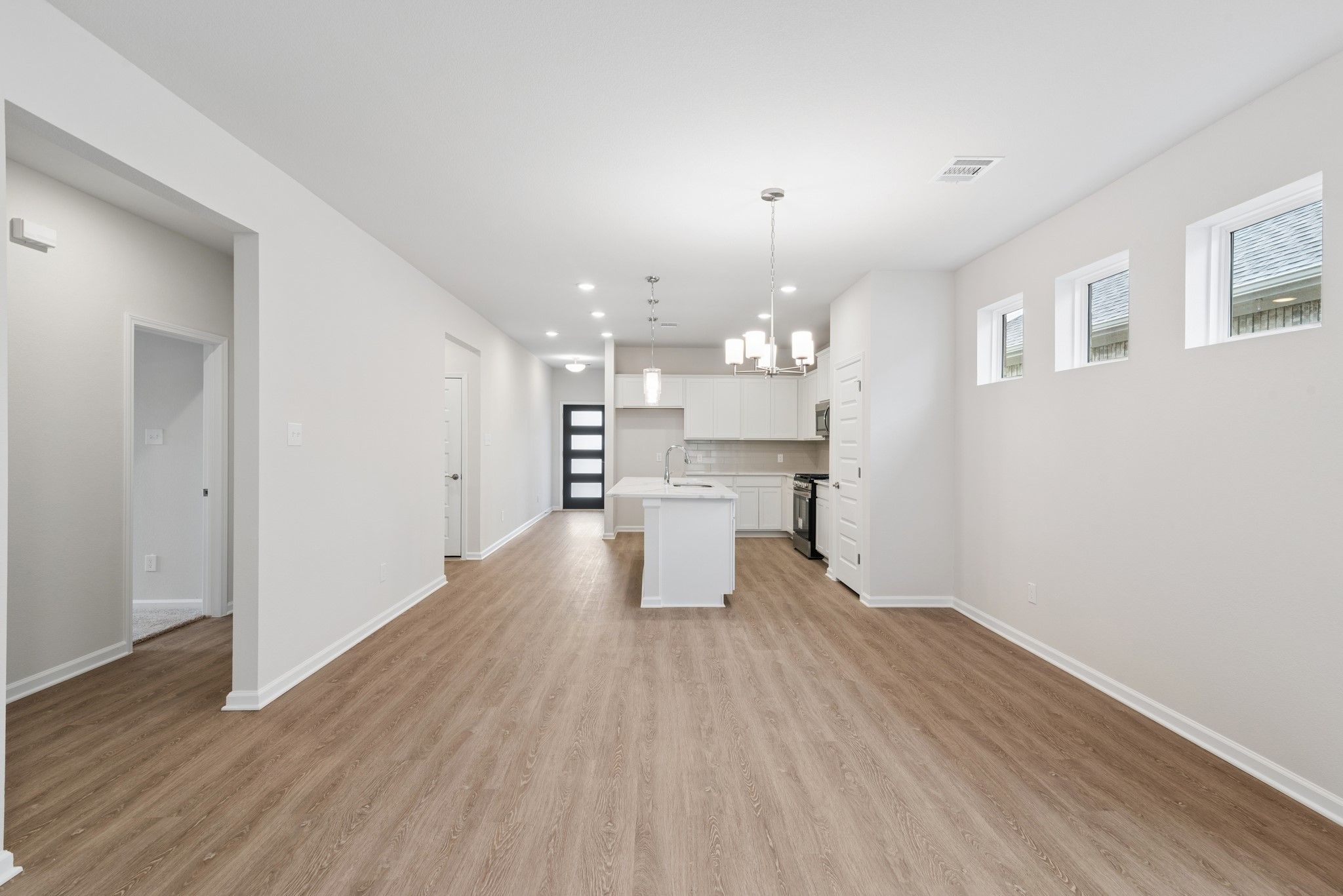 The Oakshire II- Family Room into the Dining Area and Kitchen. Home under construction, photo used