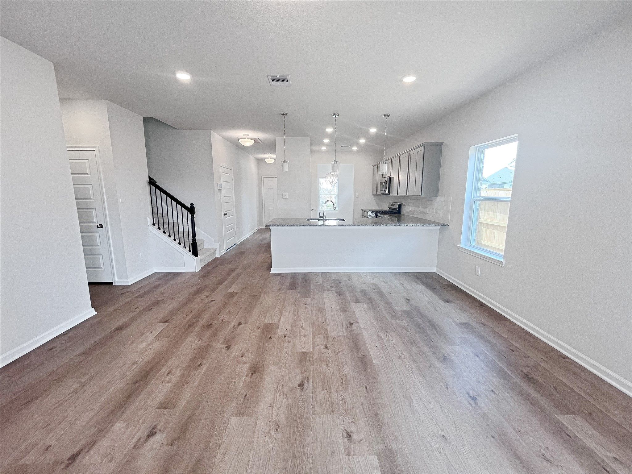 The Caldwell- Family Room into Kitchen. Sample image for illustration; upgrades, options, and color