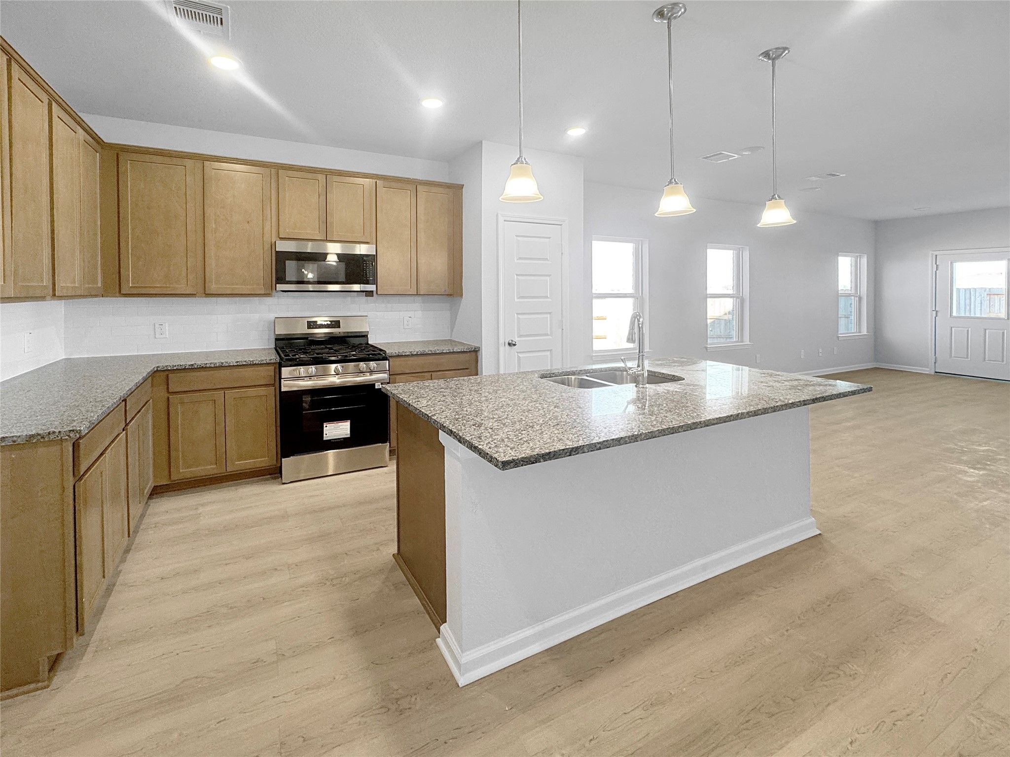 The Waring III- Kitchen into Family Room. Under construction, options, upgrades and colors will var