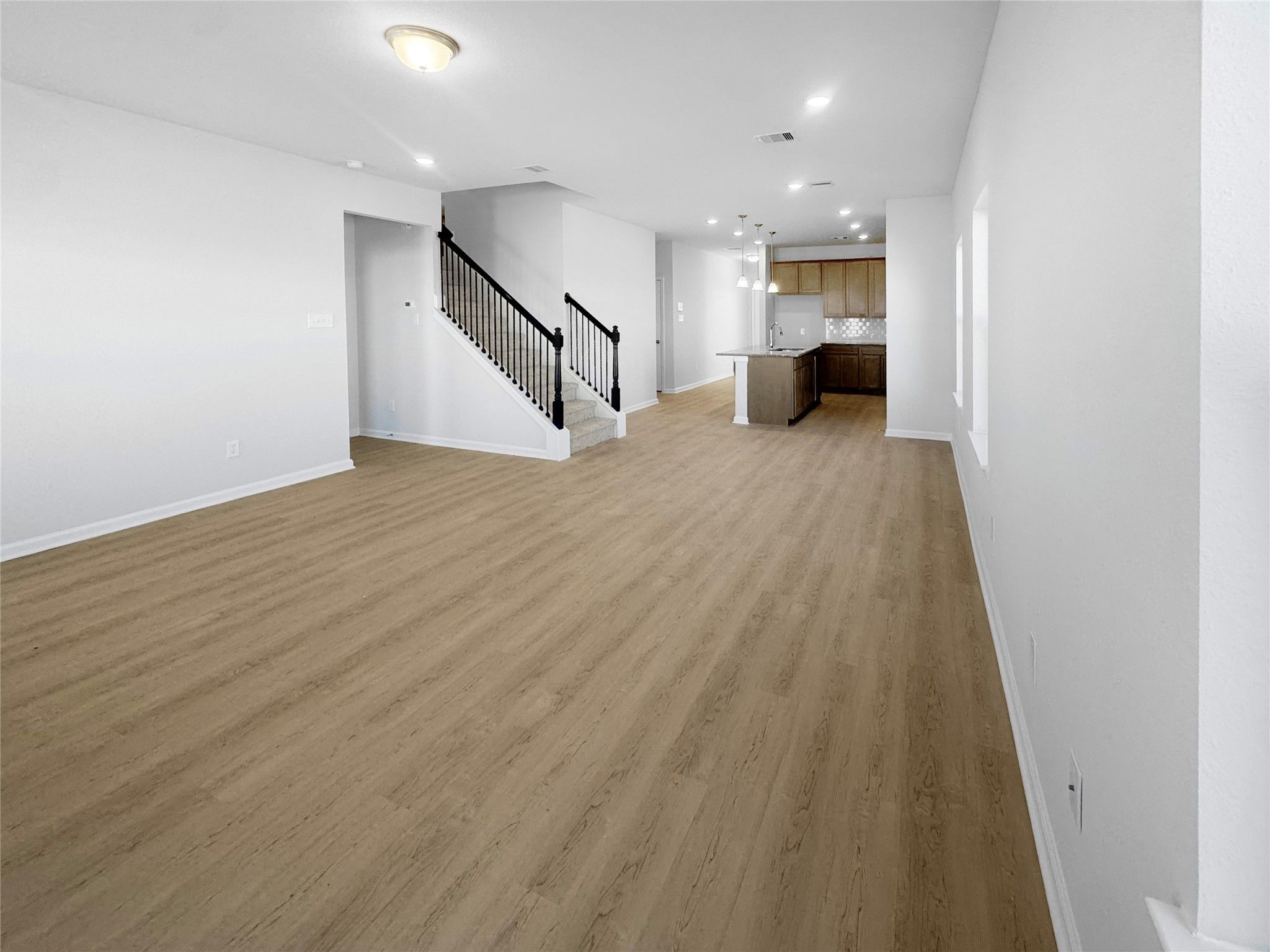 The Waring III- Family Room into Kitchen. Under construction, options, upgrades and colors will var