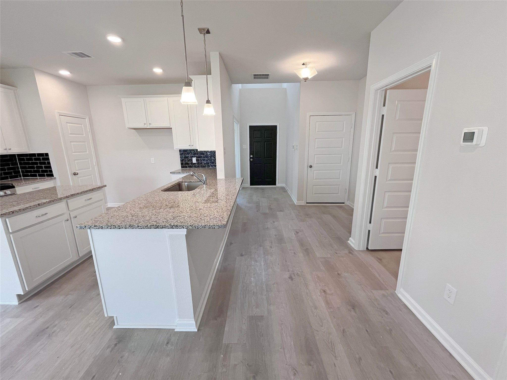 The Georgetown II- Kitchen and Foyer. Sample image for illustration; upgrades, options, and colors