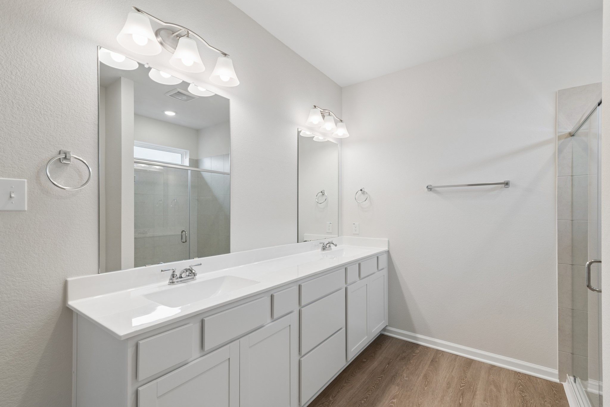 The Oakshire II- Primary Bathroom with Dual Vanities and Walk-In Shower.  Sample image for illustra