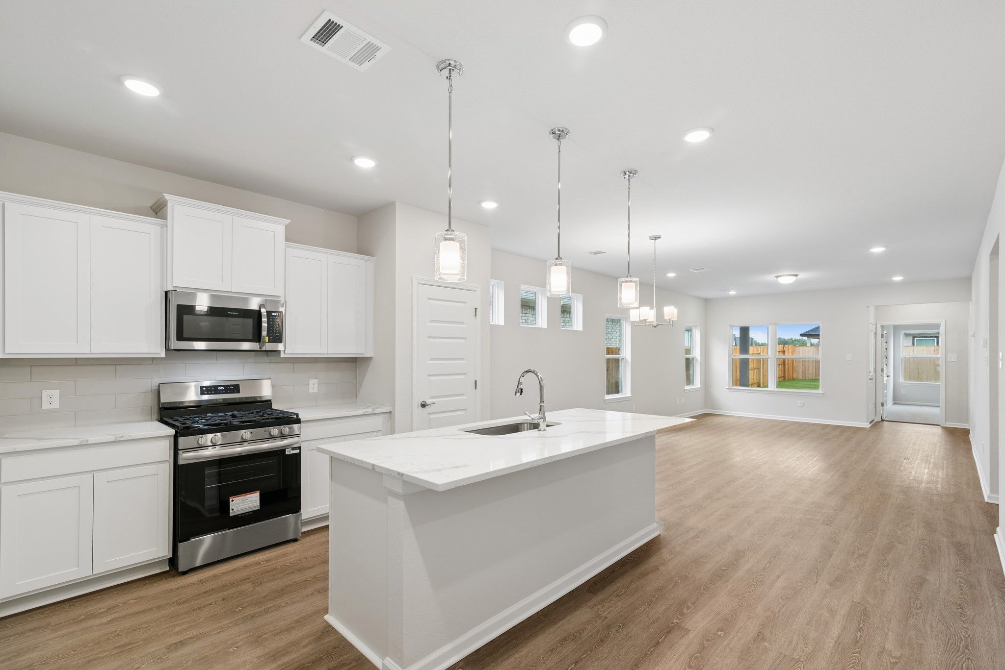The Oakshire II- Kitchen in Dining Area and Family Room.  Sample image for illustration; upgrades,