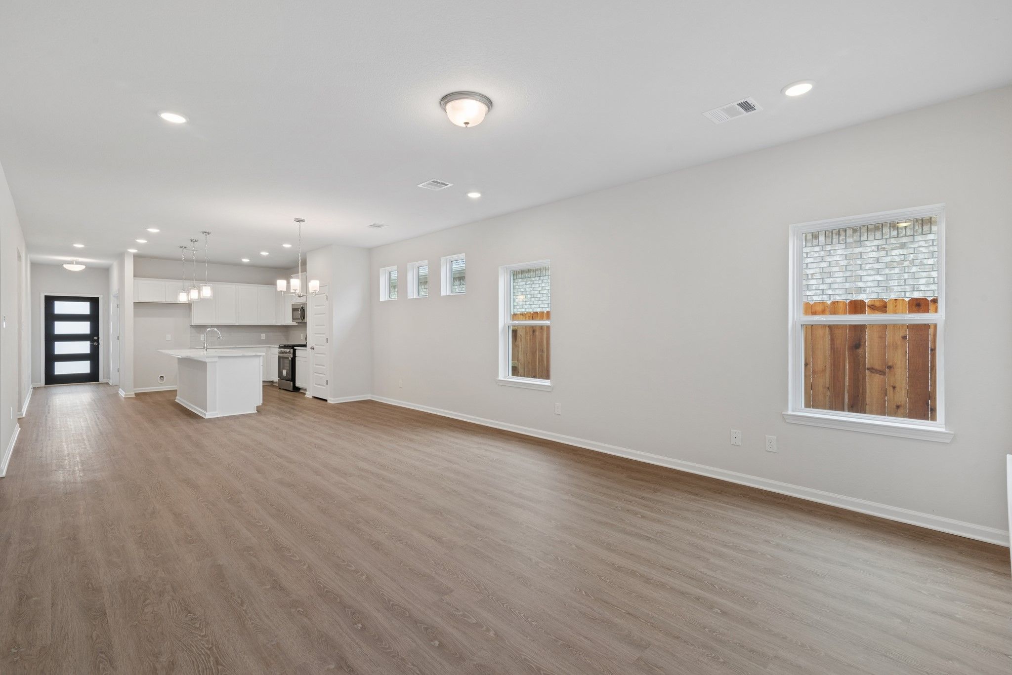 The Oakshire II- Family Room into the Dining Area and Kitchen.  Sample image for illustration; upgr