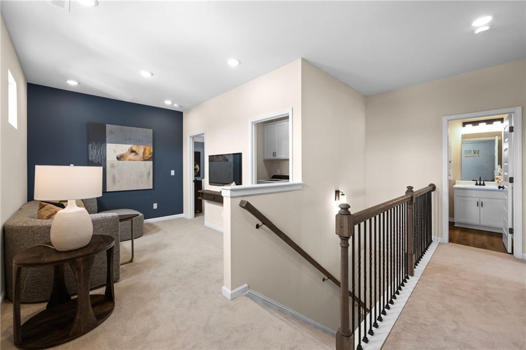 Open loft space featuring carpet flooring and recessed lighting
