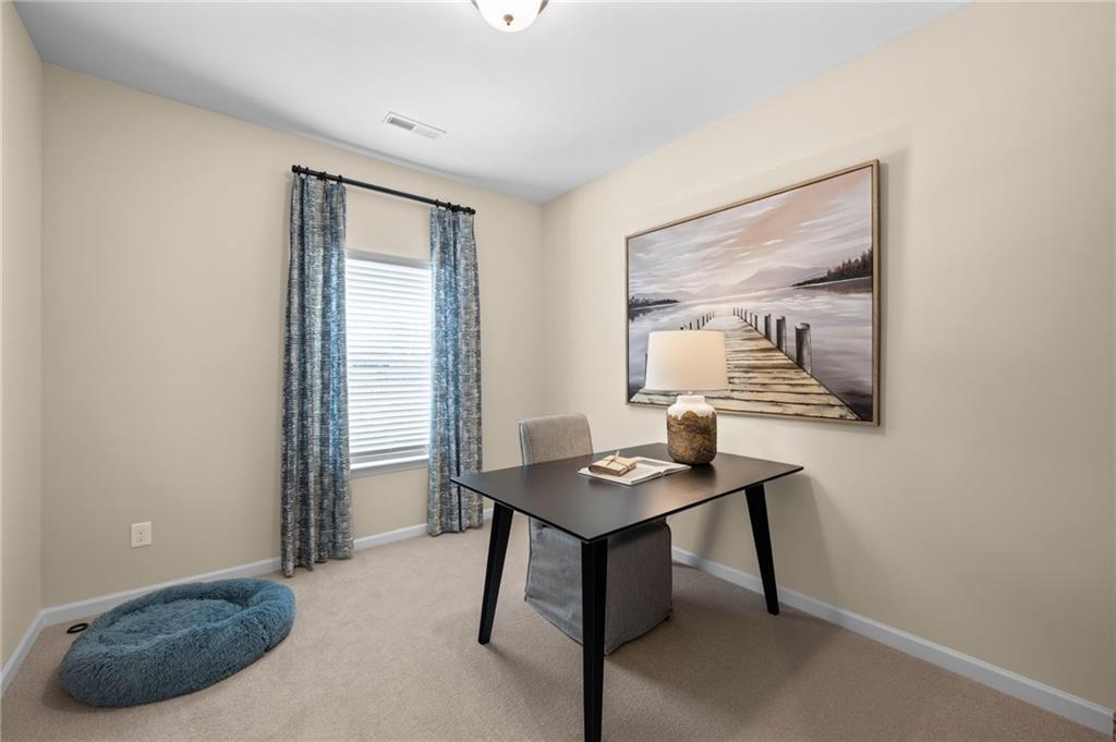 Neutral wall paint, window with blinds, and carpet flooring