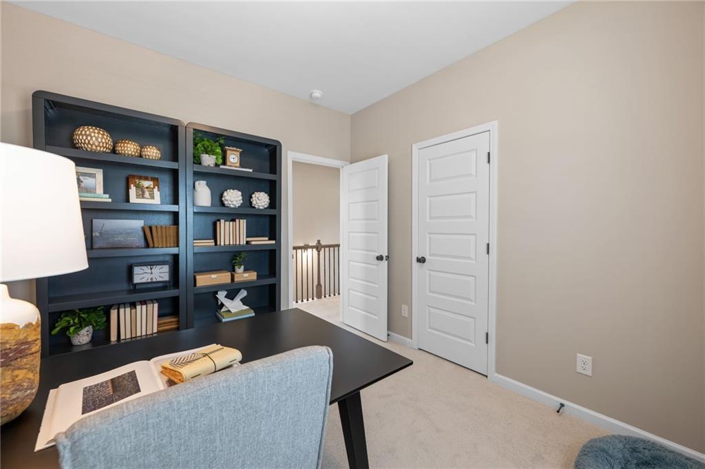 Neutral tone wall paint, carpet flooring, multiple panel interior doors, and built-in shelving