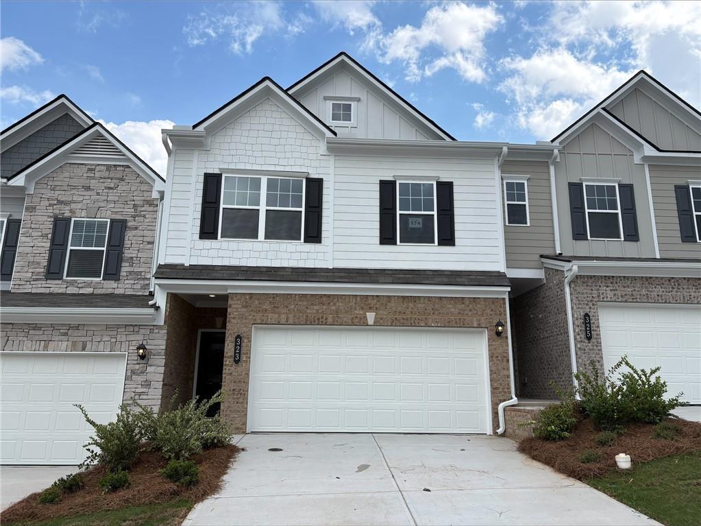 Two-story exterior with a mixed material facade, featuring brick, siding, and shake accents