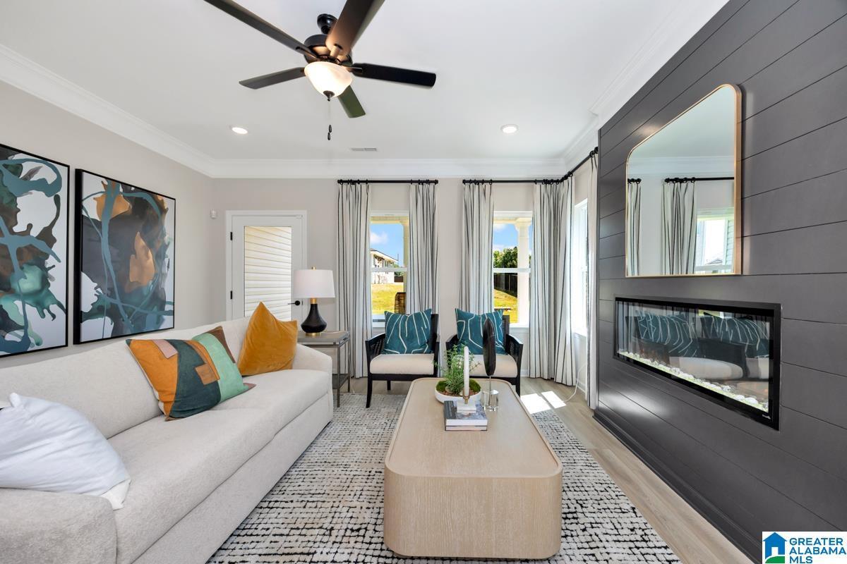 Recessed lighting, crown molding, and a ceiling fan with integrated light