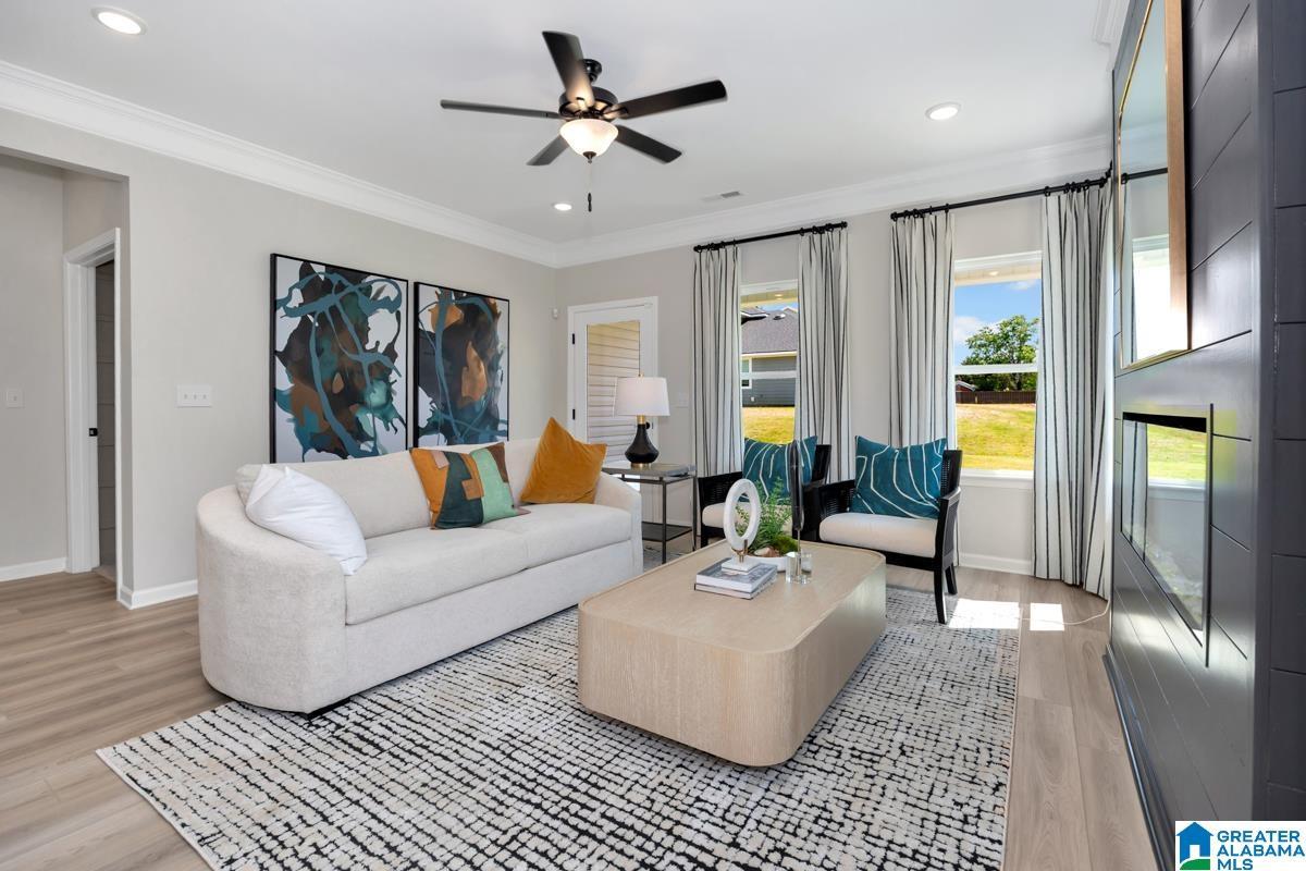 Recessed lighting, crown molding, wood-finish flooring, and a ceiling fan with integrated lighting