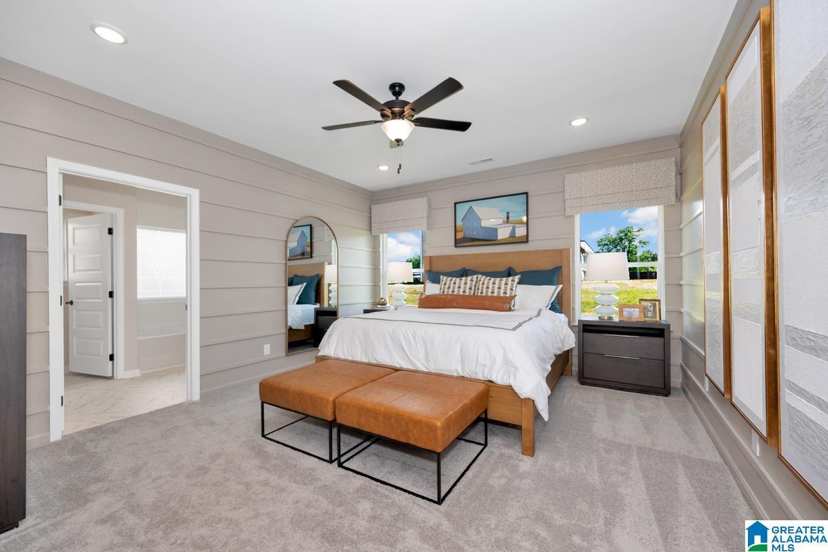 Spacious room featuring light gray shiplap walls, soft gray carpeting, a contemporary ceiling fan, and recessed lighting