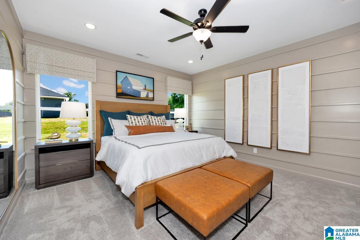 Carpeted bedroom featuring shiplap accent wall, recessed lighting, and a ceiling fan with integrated light