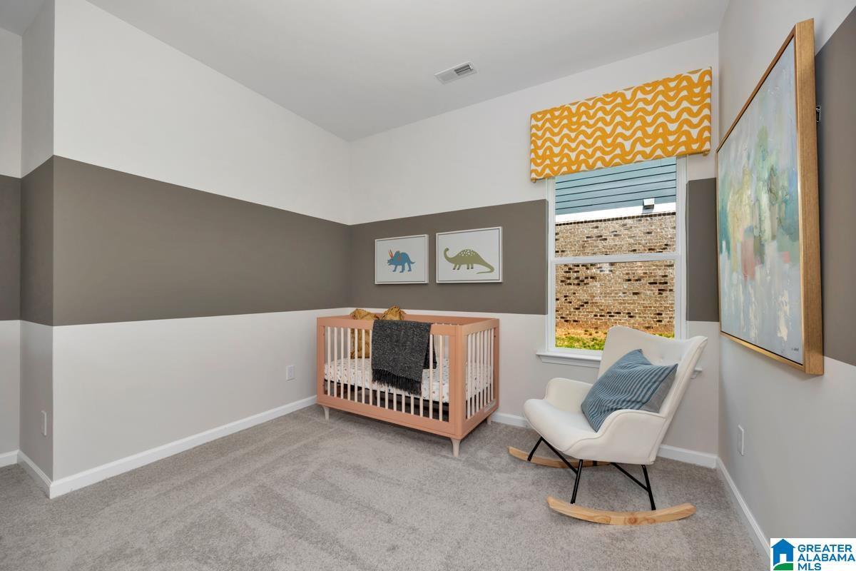 Window with a patterned valance, gray carpeting, and two-tone wall treatment