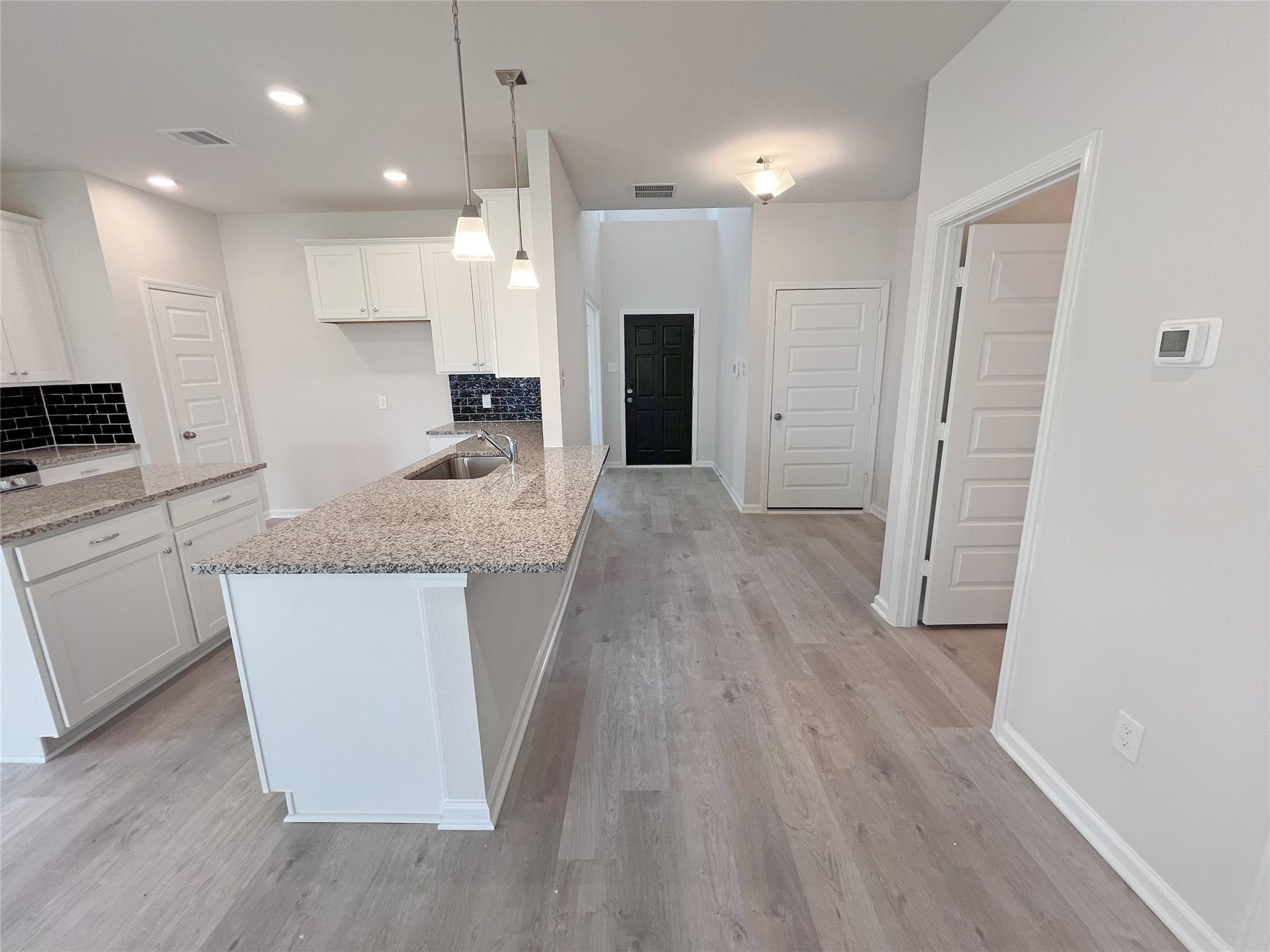 The Georgetown II- Kitchen and Foyer. Sample image for illustration; upgrades, options, and colors may vary.