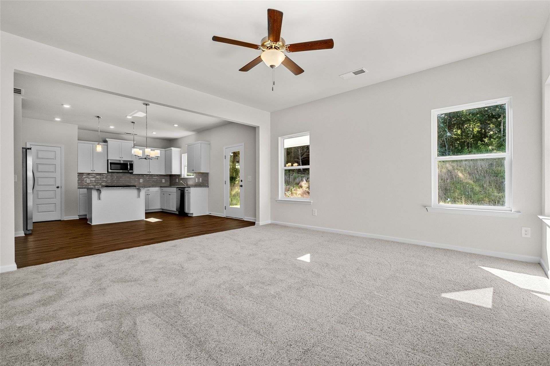 The Coleman- Family Room into kitchen. Home under construction, photo used for illustrative purposes only, colors and options will vary.