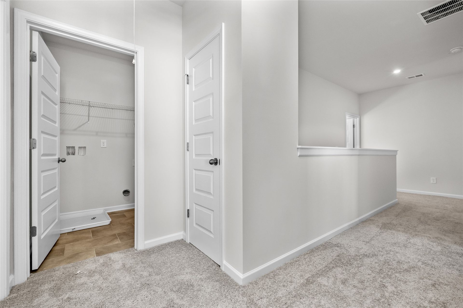 The Coleman- 2nd floor landing into utility room. Home under construction, photo used for illustrative purposes only, colors and options will vary.