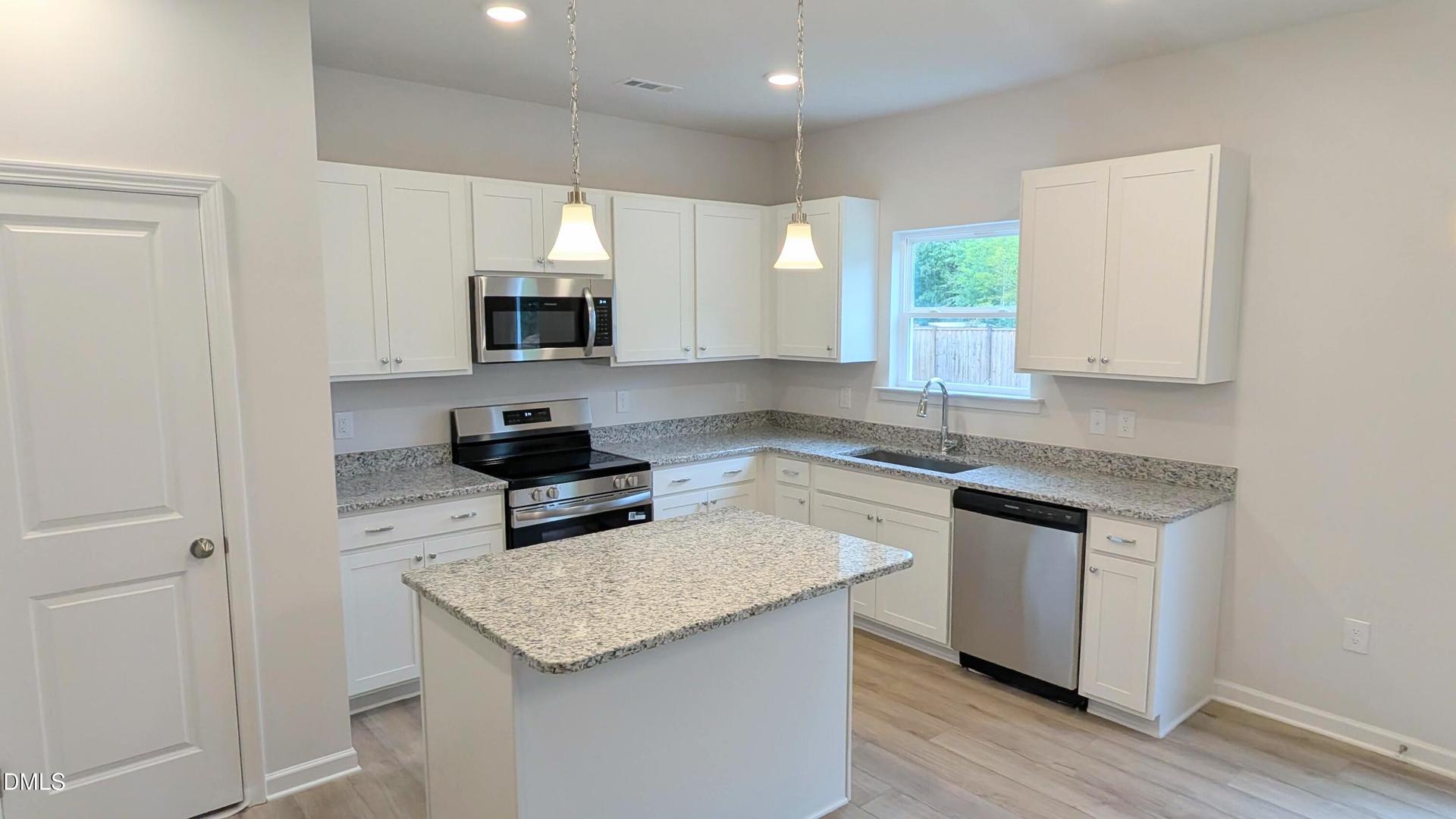 Sleek Granite and White Cabinetry