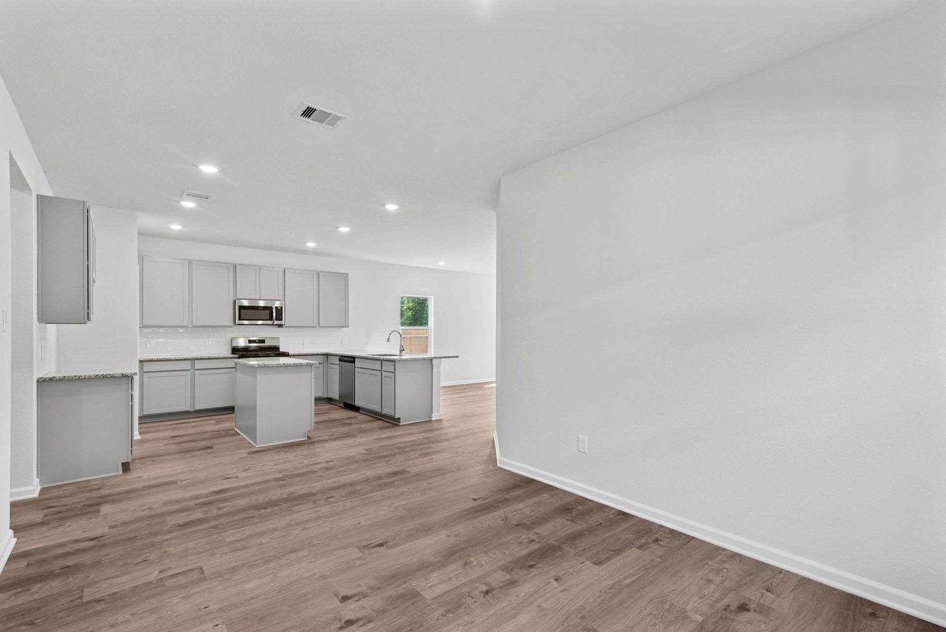The Sparrow II- Dining into Kitchen. Sample floor plan image for illustration; upgrades, options, and colors may vary.