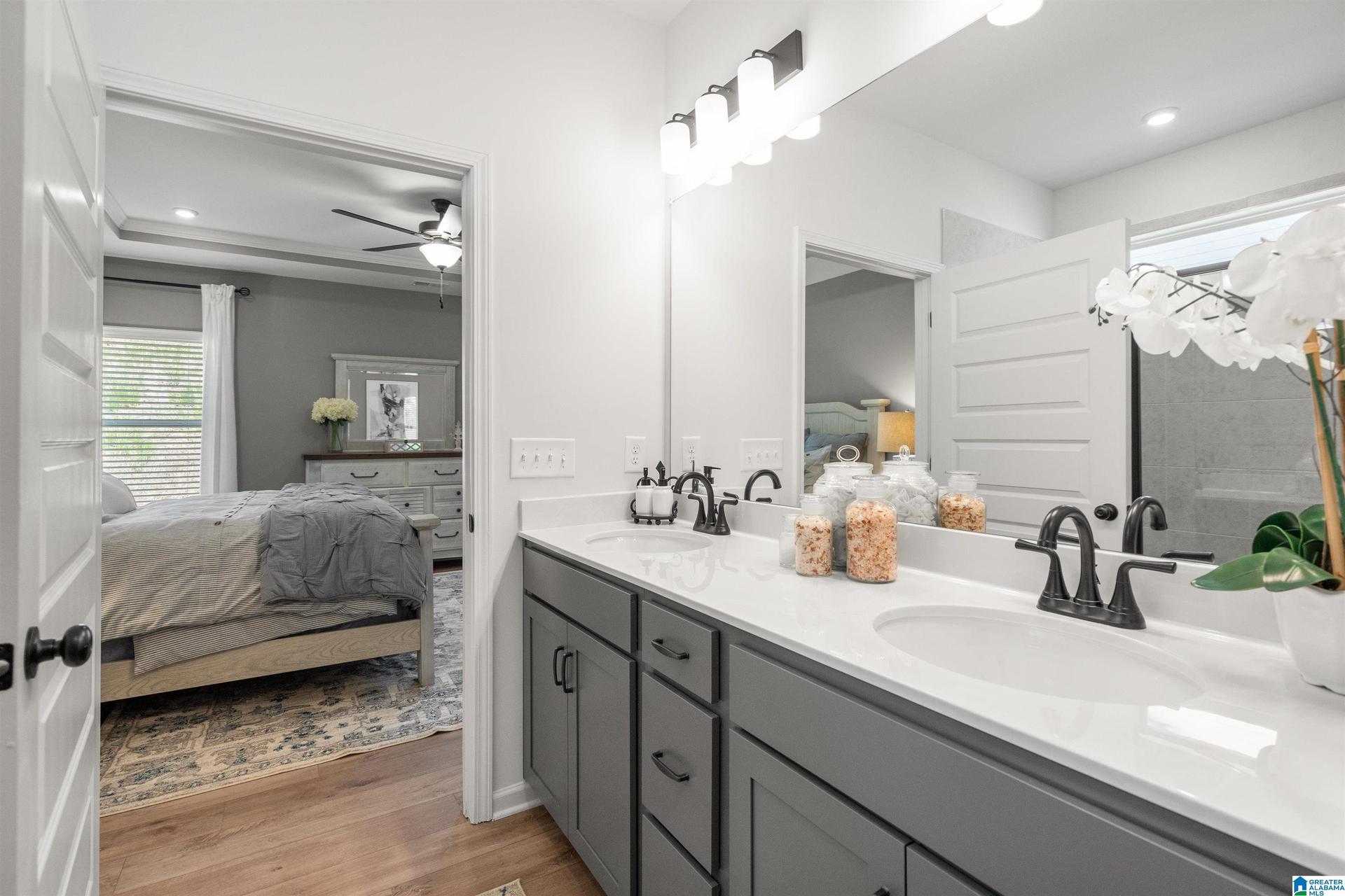 Dual vanity with undermount sinks, quartz countertop, and matte black fixtures