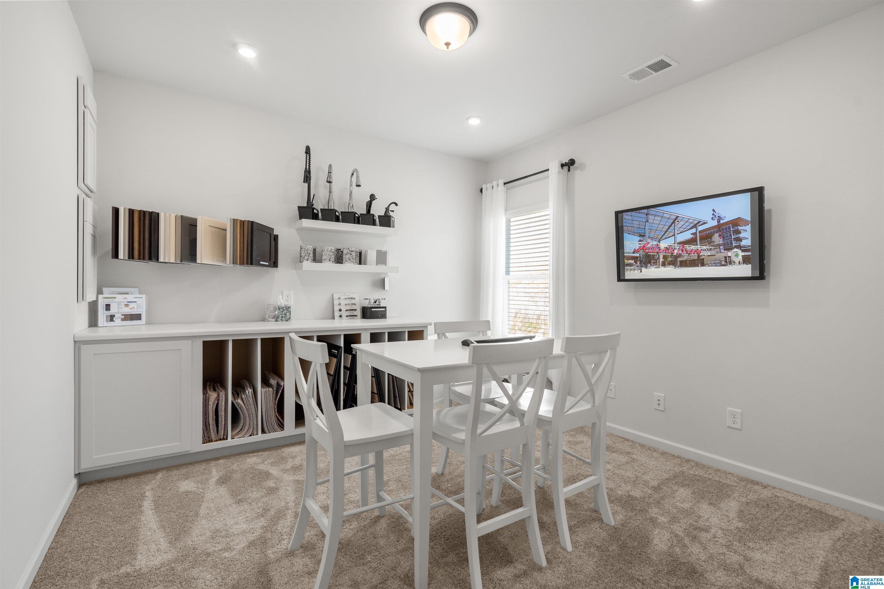 Built-in cabinetry with open shelving, recessed lighting, wall-mounted display, and a window with blinds