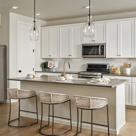 Kitchen with White Cabinetry and Pendant Lighting Over the Island