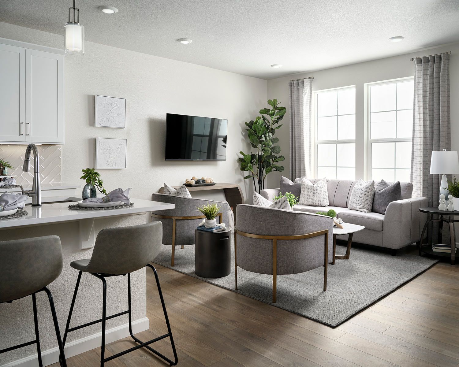 Bright and welcoming great room with laminate wood flooring