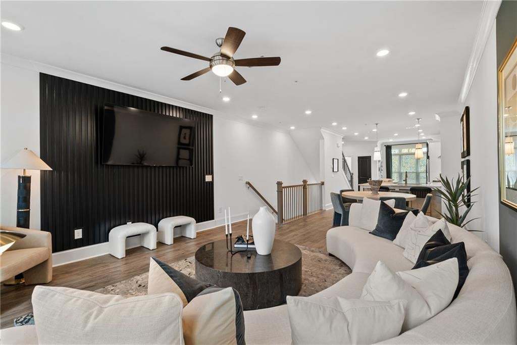 Spacious open-concept room with hardwood style flooring and recessed lighting. *Photos are not the actual unit, but of the same floor plan and decorated model home.