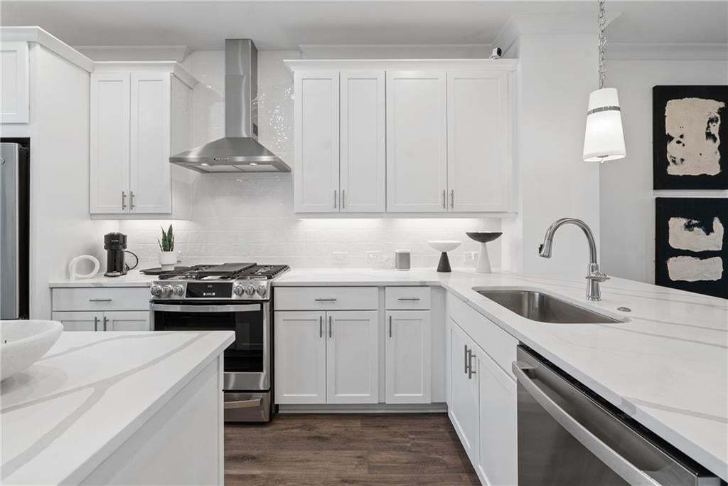 GE Stainless steel appliances with vent hood, and recessed lighting. *Photos are not the actual unit, but of the same floor plan and decorated model home.