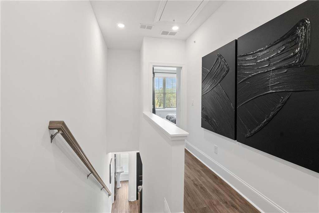 Bright and modern third-floor hallway featuring wood flooring, recessed lighting, and natural light. Clean lines and contemporary artwork can add a refined touch to the space. *Photos are not the actual unit, but of the same floor plan and decorated mode