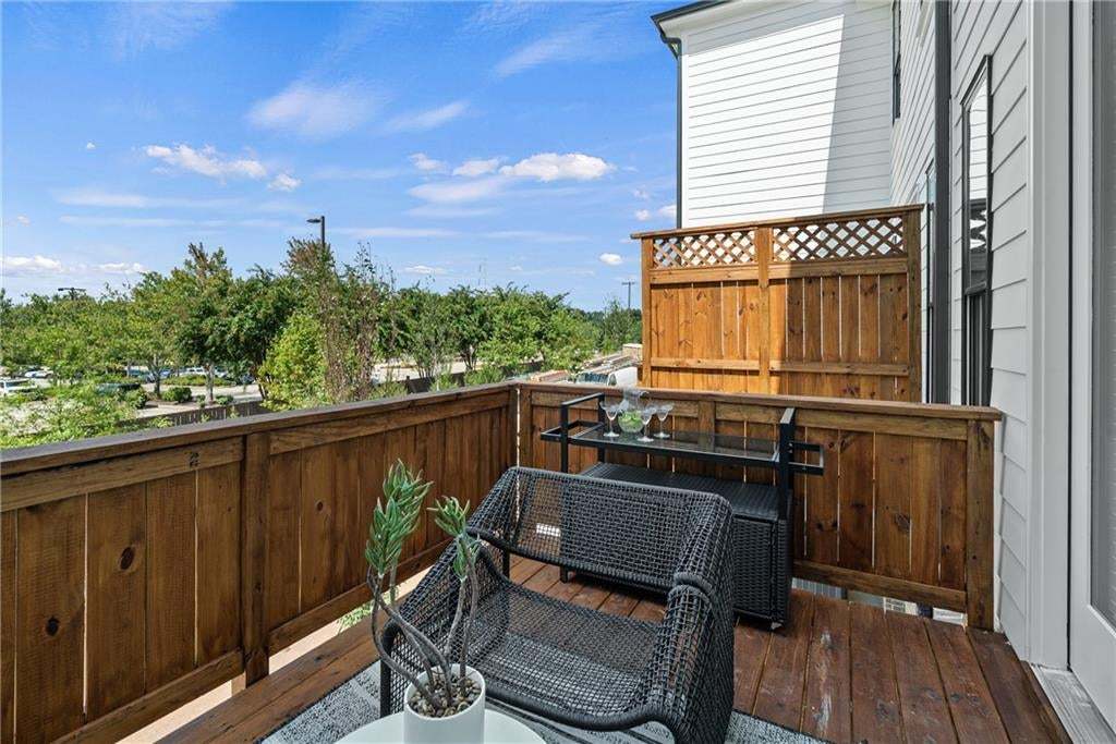 Cozy outdoor deck with wood flooring and railing, offering a private space to relax and enjoy the surrounding views. *Photos are not the actual unit, but of the same floor plan and decorated model home.