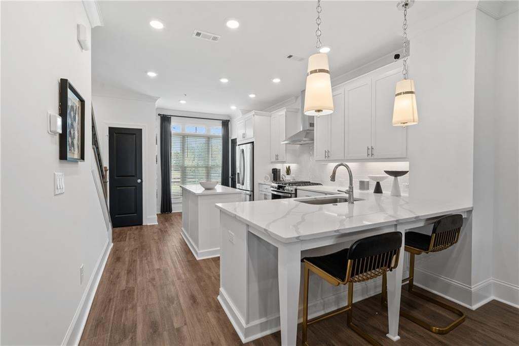 Double quartz islands with GE Coffee Series ( refrigerator, Washer and Dryer , Blinds not standard)  not the actual unit or building