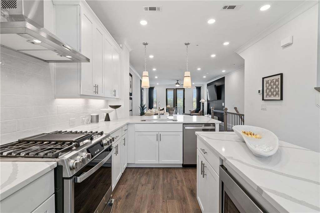 42" Stain Cabinets soft closing  , Quartz Countertops , Range Hood , Electrical Oven , Gas Cooktop , Built in Microwave , not the actual unit or building